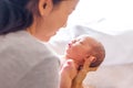 Young mother holding her little newborn baby girl, smiling Royalty Free Stock Photo