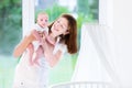 Young mother holding her newborn baby at crib Royalty Free Stock Photo