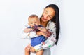 Young mother holding her newborn child. Baby soiled by paints with mother. Mom hugging and carrying her baby boy. Close Royalty Free Stock Photo