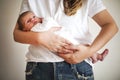 Young mother holding her newborn child. Mom nursing baby. Family Royalty Free Stock Photo