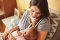 Young mother holding her newborn child. Mom nursing baby. Family Royalty Free Stock Photo