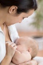 Young mother holding her newborn child. Mom nursing baby. Pretty woman breast feeding kid. Royalty Free Stock Photo
