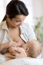 Young mother holding her newborn child. Mom nursing baby. Pretty woman breastfeeding kid. Royalty Free Stock Photo