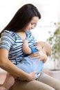 Young mother holding her newborn child. Mom nursing baby. Royalty Free Stock Photo