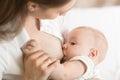 Young mother holding her newborn child. Mom nursing baby. Pretty woman breastfeeding kid. Royalty Free Stock Photo