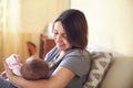 Young mother holding her newborn child. Mom nursing baby. Royalty Free Stock Photo