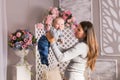 Young mother holding her newborn child. Woman and baby boy relax in a white bedroom. Nursery interior. Family at home Royalty Free Stock Photo