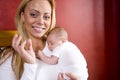 Young mother holding newborn baby boy in arms Royalty Free Stock Photo