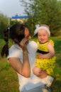 Young mother holding a small daughter in her arms