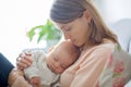 Young mother, holding tenderly her newborn baby boy Royalty Free Stock Photo