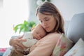 Young mother, holding tenderly her newborn baby boy Royalty Free Stock Photo