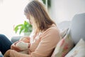 Young mother, holding tenderly her newborn baby boy Royalty Free Stock Photo