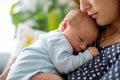 Young mother, holding tenderly her newborn baby boy Royalty Free Stock Photo