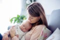 Young mother, holding tenderly her newborn baby boy Royalty Free Stock Photo