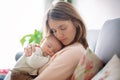 Young mother, holding tenderly her newborn baby boy Royalty Free Stock Photo