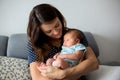 Young mother, holding tenderly her newborn baby boy Royalty Free Stock Photo