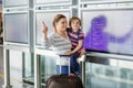 Young mother holding toddler son, cute child at airport. Little kid boy and mum, family traveling together, going on Royalty Free Stock Photo