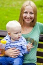 Young mother holds on hands of his two year old son Royalty Free Stock Photo