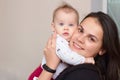 young mother holds her funny, sweet baby in her arms Royalty Free Stock Photo