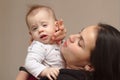 young mother holds her funny, sweet baby in her arms Royalty Free Stock Photo