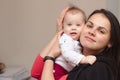 young mother holds her funny, sweet baby in her arms Royalty Free Stock Photo