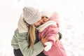 Young mother holds her little daughter in her arms and kisses her. Family portrait. Motherhood and childhood Royalty Free Stock Photo