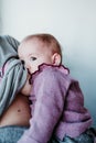 young mother at home breast feeding her adorable one year old baby girl. family time Royalty Free Stock Photo