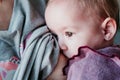 young mother at home breast feeding her adorable one year old baby girl. family time Royalty Free Stock Photo