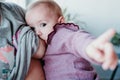 young mother at home breast feeding her adorable one year old baby girl. family time Royalty Free Stock Photo