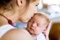 Young mother at home holding her newborn baby daughter Royalty Free Stock Photo