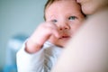 Young mother hugging her newborn child. Mom nursing baby. Family at home. Love, trust and tenderness concept. Royalty Free Stock Photo