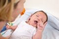 Young mother hugging her newborn child. Mom nursing baby. Family at home. Love, trust and tenderness concept. Royalty Free Stock Photo