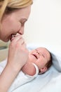 Young mother hugging her newborn child. Mom nursing baby. Family at home. Love, trust and tenderness concept. Royalty Free Stock Photo