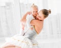 Young mother hugging little smiling daughter in ballet studio Royalty Free Stock Photo