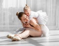 Young mother hugging little smiling daughter in ballet studio Royalty Free Stock Photo