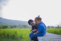 Young mother hugging and soothing a crying little long hair boy, Asian mother trying to comfort and calm down her crying child