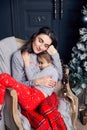 Young mother hugs daughter in pajamas holding her in her arms Royalty Free Stock Photo