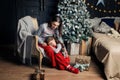 Young mother hugs daughter in pajamas holding her in her arms. The girl put her head on her mothers lap Royalty Free Stock Photo