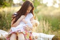 Young mother with infant baby outdoors