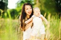 Young mother with infant baby outdoors