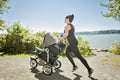 Young mother jogging with a baby buggy Royalty Free Stock Photo