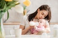 Young woman kiss baby during drinking milk Royalty Free Stock Photo