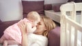 Young mother kissing baby at home. Love and happiness concept Royalty Free Stock Photo