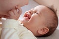 Young mother, kissing her baby boy at home. Family concept. Closeup portrait of loving mother young woman kissing little Royalty Free Stock Photo