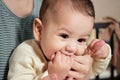 Young mother, kissing her baby boy at home. Family concept. Closeup portrait of loving mother young woman kissing little Royalty Free Stock Photo