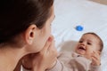 Young mother, kissing her baby boy at home. Family concept. Closeup portrait of loving mother young woman kissing little Royalty Free Stock Photo