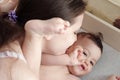 Young mother, kissing her baby boy at home. Family concept. Closeup portrait of loving mother young woman kissing little Royalty Free Stock Photo