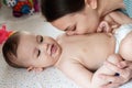 Young mother, kissing her baby boy at home. Family concept. Closeup portrait of loving mother young woman kissing little Royalty Free Stock Photo