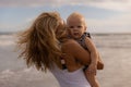 Young mother kissing her baby son. Mum with infant spending time on the beach. Summer vacation in Asia. Family concept. Happy Royalty Free Stock Photo