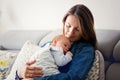 Young mother, kissing her newborn baby boy at home Royalty Free Stock Photo